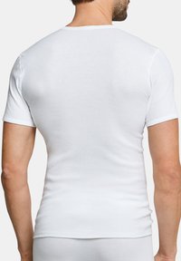 T-shirt bianca a maniche corte, realizzata in tessuto a coste, dal design aderente, con una texture liscia, girocollo, e dettagli di cucitura sottili sulle maniche.