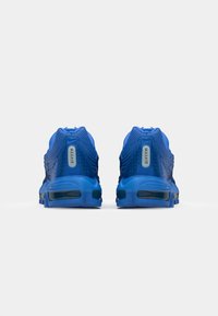 Blue athletic sneakers with mesh upper, prominent Max Air cushioning, and textured detailing on the heel and sole.