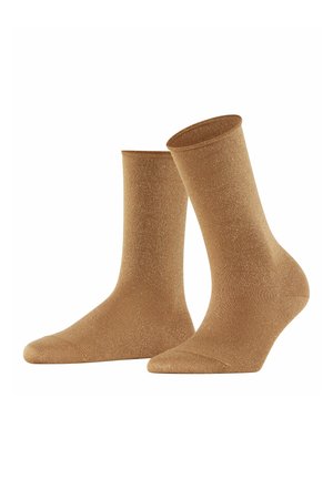 Braune Knöchelsocken aus einem glänzenden, strukturierten Material mit einem subtilen Schimmer. Mit einem gerippten Bündchen sowie verstärkten Zehen- und Fersenbereichen.