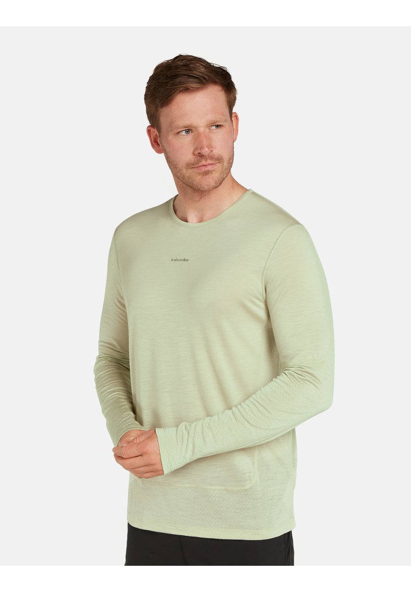Hellgrünes Langarmshirt aus weichem Stoff, mit Rundhalsausschnitt und Daumenlöchern an den Ärmeln, sowie einem dezenten Logo auf der Brust.