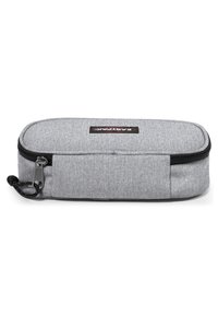 Astuccio grigio con esterno in tessuto testurizzato, chiusura con zip e un'etichetta logo nera. Presenta un design compatto e rettangolare.