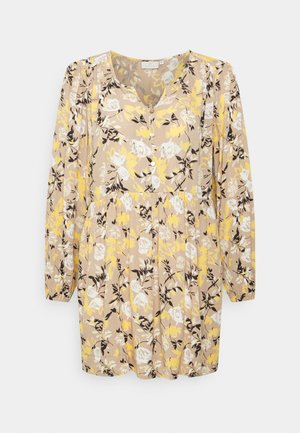 Vestido floral em bege com padrões amarelos, brancos e pretos. Decote em V, mangas longas, detalhes em botão e cintura franzida.