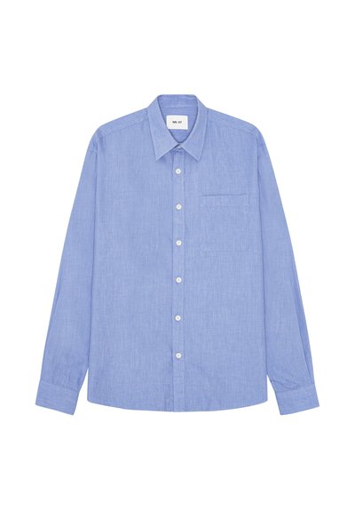 Camicia azzurro chiaro a maniche lunghe con bottoni, colletto appuntito e una tasca sul petto, distesa su uno sfondo bianco.