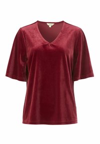 Burgundy sametti ylätoppi V-kaula-aukolla ja lyhyillä hihoilla. Sujuva pinta, löysä istuvuus ja vähäiset ommel-yksityiskohdat.