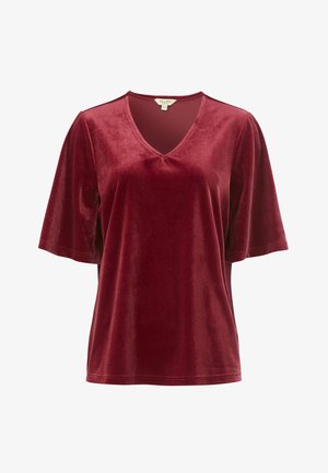 Burgundy sammetstopp med V-ringning och korta ärmar. Slät yta, lös passform och minimala sömnadsdetaljer.