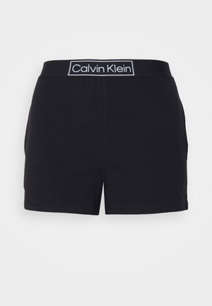 Melni šorti ar mīkstu tekstūru un elastīgu jostasvietu, uz kuriem redzams "Calvin Klein" uzraksts baltā krāsā. Taisnas griezuma ar izšūtu apakšmalu.