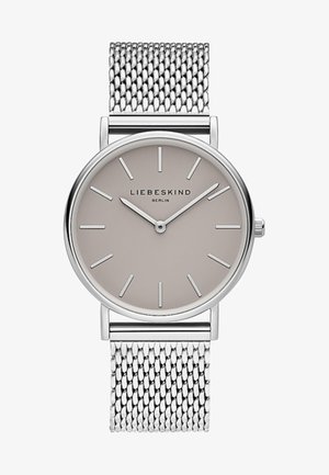 Sølvmeshrem med en rund, lysegrå urskive. Tynde markører og visere til tidsangivelse. Mærket "Liebeskind Berlin" vist.