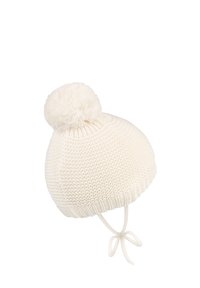 White knitted hat with a rounded shape, featuring a soft pom-pom on top and tie straps for secure wear. Textured fabric design.