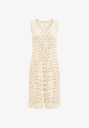 Beige mouwloze open voorzijde gehaakte vest met striksluiting, voorzien van een V-hals en ingewikkelde kantpatronen bij de zoom en halslijn.