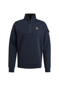 Jersey de color azul marino hecho de suave forro polar, con cierre de cuarto, cuello alto y un bolsillo en la manga izquierda con un parche decorativo.