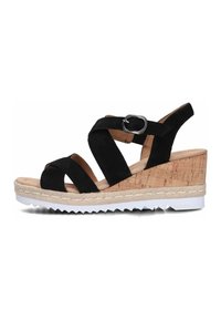 Black suede wedge sandal with adjustable buckle, cork-like base, white cleated outsole, and multiple crisscross straps on the front.