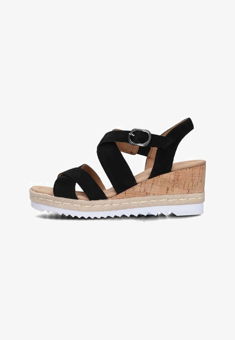 Black suede wedge sandal with adjustable buckle, cork-like base, white cleated outsole, and multiple crisscross straps on the front.