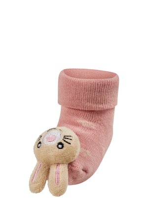 Pink ribbed sock with a fold-over top, featuring a fluffy bunny face and ears as a decorative element on the toe. Soft texture.