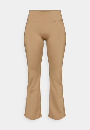Tan flared leggings lavet af strækbart stof, med en høj talje. Glat tekstur med minimal syning.
