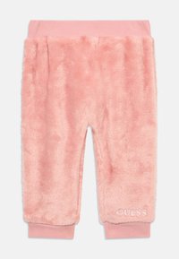 Pantaloni sportivi rosa e morbidi realizzati in materiale soffice. Presentano un elastico a coste in vita e un logo del brand ricamato sull'orlo. Lunghezza a metà polpaccio.