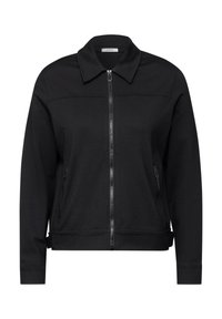 Schwarze Zip-Jacke aus weichem Material. Verfügt über einen Kragen, seitliche Reißverschlusstaschen und einen taillierten Saum. Einfaches Design ohne Muster.