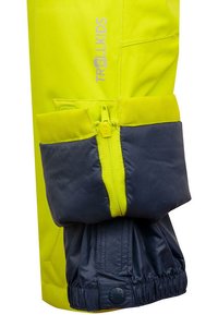 Wasserdichte Kinderhose in leuchtendem Gelb und Marineblau mit Reißverschluss und elastischen Bündchen; mit Logodetail am Bein.