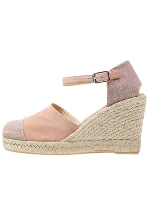 Pink suede wedge espadrille with a metallic accent, ankle strap, and braided jute sole. The toe features a textured fabric cap.