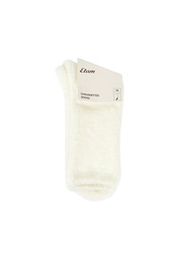 Weiße, flauschige Socken mit weicher Textur und umgeschlagenem Bündchen. Enthält ein Etikett mit der Marke "Etam" und der Größe "TU".