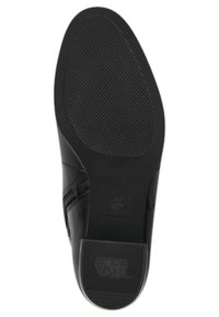 Semelle de chaussure noire avec une surface texturée, fabriquée en matériaux en caoutchouc flexibles, de forme arrondie et avec un logo sur le côté.