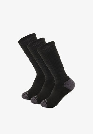 Trois chaussettes noires basses avec des bouts et des talons renforcés gris, alignées côte à côte sur un fond blanc.
