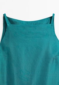 Teal sleeveless dress with thin straps and straight neckline made of lightweight fabric.