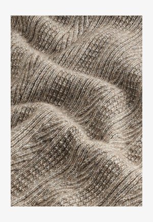 Struktuurne pruun kudum kangas lainelise mustriga, erinevate beežide ja heledate pruuni varjunditega. Pehme, mugav välimus koos nähtavate õmblustega.