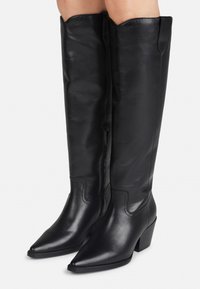 Black leather knee-high boots with a pointed toe, block heel, and stitched detailing. Smooth texture and a slightly glossy finish.