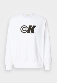 Felpa bianca in cotone con stampa del logo Calvin Klein nera. Presenta un colletto a girocollo e polsini e bordo a costine.