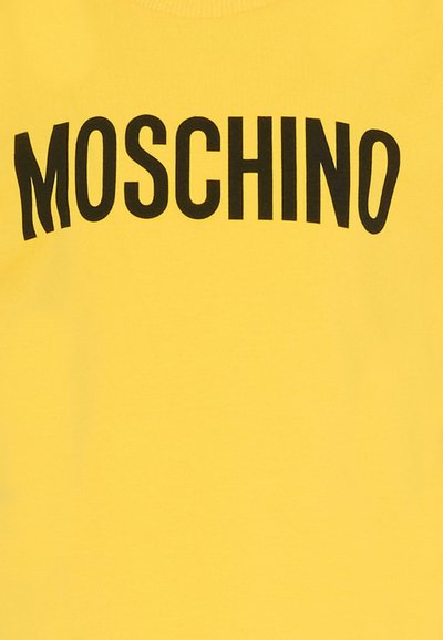 Sweat-shirt en coton jaune avec un grand logo "MOSCHINO" noir en design courbé sur la poitrine, à la texture lisse et mate.