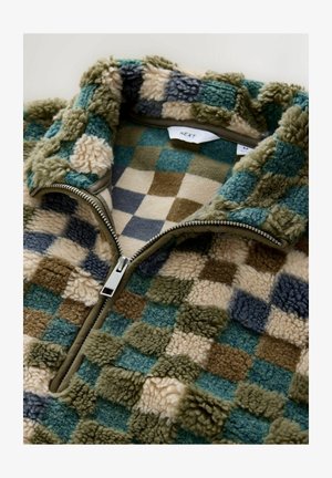 Polarowy pulower z kołnierzem na zamek, ozdobiony wielokolorowym wzorem w kratę w odcieniach zieleni, niebieskiego, beżu i brązu. Miękka, strukturalna tkanina.