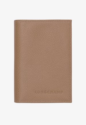 Light brown textured leather wallet with stitched edges and embossed "LONGCHAMP" logo on the front center.