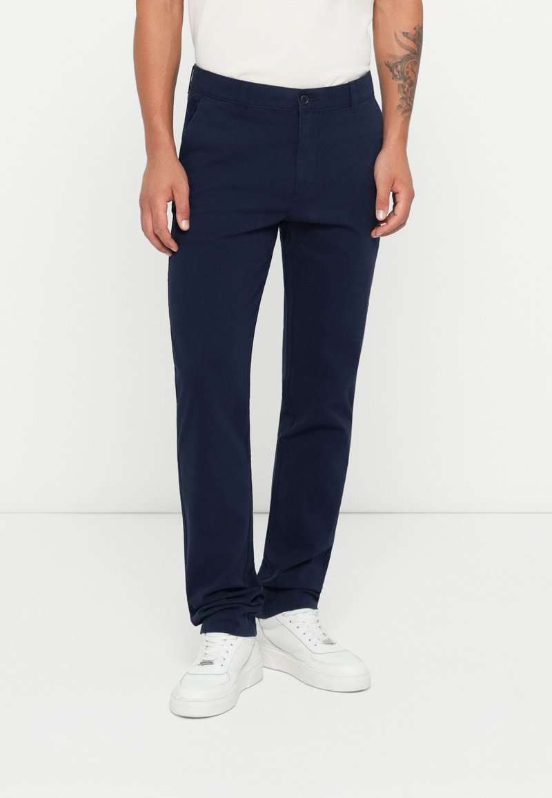 Navy blue cotton pants with a straight-leg design, featuring a button and zipper closure, side pockets, and a smooth texture.