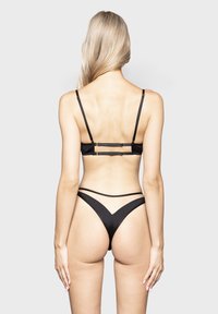 Black bikini set with adjustable straps, featuring a sleek design. The top has a double-band back, and the bottom has a V-cut shape.