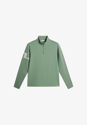 Langærmet quarter-zip trøje i salviegrøn med opretstående krave og et hvidt mønstret logo på venstre ærme.