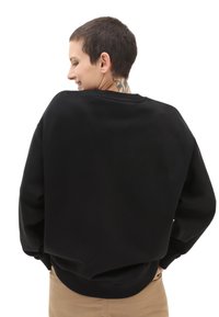 Zwarte sweatshirt met een relaxed fit, geribbelde mouwen en onderkant, met een zachte textuur en verlaagde schouders voor een eigentijdse uitstraling.