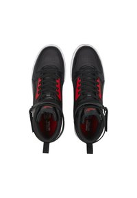 Black and red high-top sneakers with smooth leather upper, circular perforations on the toe, contrasting red accents, and white rubber sole.