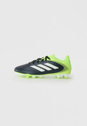 Scarpa da football con tomaia in sintetico nero, accenti verde neon, strisce bianche e un design testurizzato. Suola in gomma con tacchetti.