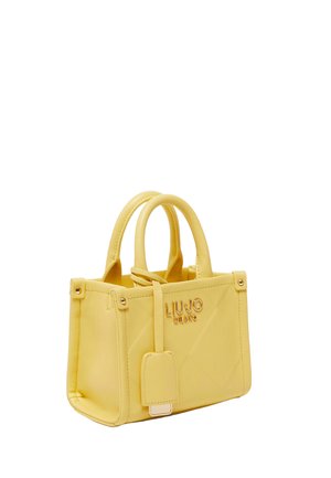 Yellow tote bag with two handles, front tag, and "Liu Jo Milano" logo in gold lettering on smooth leather texture.