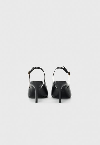 Black high-heeled sandals with a smooth leather finish, open back, ankle strap, and slender heel design. Gold-tone buckle detail.