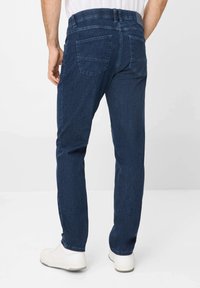 Dark blue denim jeans with a straight cut, featuring a waistband with belt loops and two back pockets. Material appears textured.