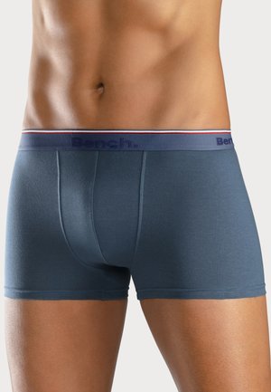 Blue cotton boxer briefs with a snug fit, featuring a dark waistband with "Bench." logo, accented by red and white stripes.