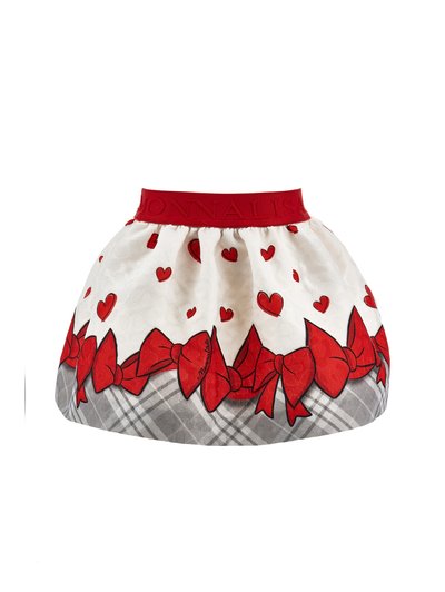Jupe blanche avec une ceinture rouge, décorée de cœurs rouges et de grands nœuds rouges au-dessus d’un motif à carreaux gris à l’ourlet.