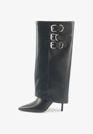 Black leather ankle boot with a pointed toe, stiletto heel, and three silver buckle accents on the side. Smooth texture, tall shaft.