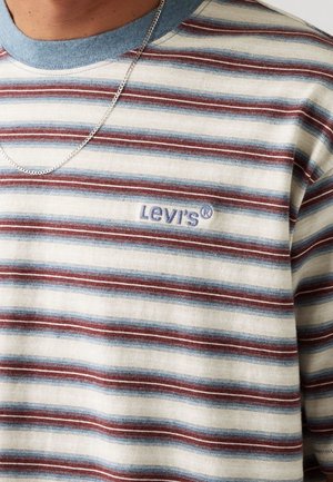 Striped short-sleeve shirt with blue and red horizontal stripes, Levi's logo embroidered on chest, and silver chain necklace on neck.