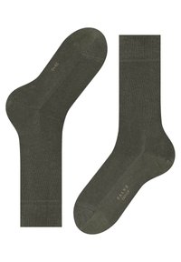 Olijfgroene sokken van zachte stof, met een ribbelmanchet en een gladde textuur. Merking in lichte kleur is zichtbaar aan de onderkant.