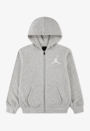Sweat à capuche zippé gris clair avec poches avant, capuche et logo Jumpman blanc sur la poitrine gauche. Aucune personne n'est présente.