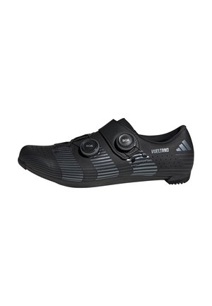Black aerodynamic cycling shoe with dual BOA dial closures, reflective gray stripes, and "VUELTANO" branding on the heel.