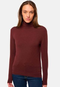Pull à col roulé bordeaux en matériau doux, avec des manches longues et une coupe ajustée, doté d'un col et d'un ourlet côtelés.