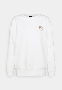 Valkoinen collegepaita, joka on valmistettu puuvillasta, pyöreällä kaula-aukolla ja pitkillä hihoilla. Vasemmassa rinnassa hopeinen lintusymboli. Minimalistinen muotoilu.